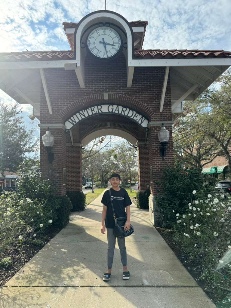 Child posing in front of the iconic clock tower in Downtown Winter Garden, Florida